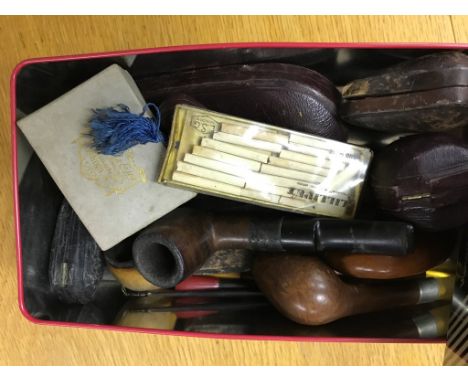 A collection of cased pipes, lighter etc