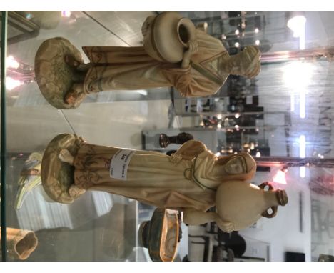 A pair of Royal Worcester blush ivory figures of water carriers