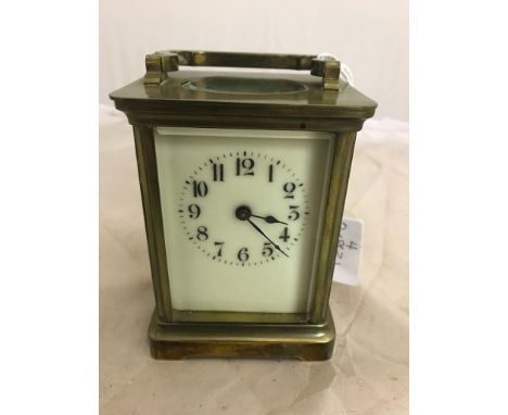 A brass carriage clock in case