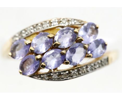 Unmarked yellow metal ring set with tanzanite coloured stones, size P, 2.2g. P&amp;P Group 1 (£14+VAT for the first lot and £