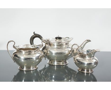 GEORGE V SILVER THREE PIECE TEA SERVICE
maker Henry Moreton, Birmingham 1920, of oval form with pierced rims of scrolling des