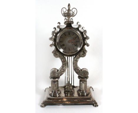 A late 19th Century Continental mantel clock
With circular dial with Roman numerals, to a brass movement striking on a bell (