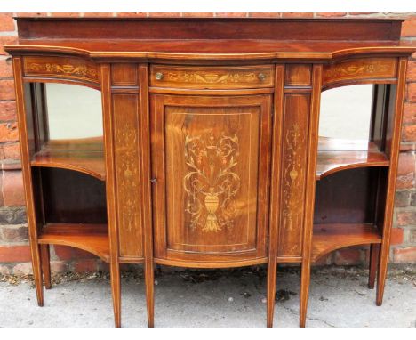 An Edwardian Sheraton revival rosewood and inlaid side cabinet 
With central bowed door and frieze drawer, flanked by two sid