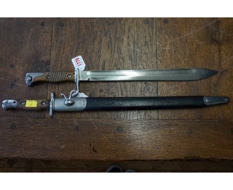 A German Mauser bayonet; together with another bayonet and scabbard. 