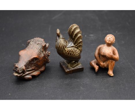 A Japanese carved wood okimono of a cockerel,&nbsp;6.2cm high; together with another erotic netsuke; and another. (3) 