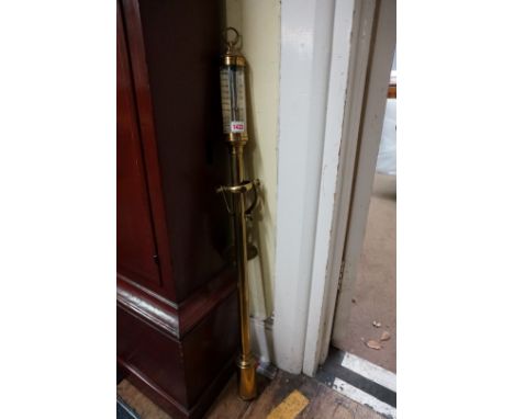 A brass marine stick barometer,&nbsp;the silvered dial inscribed 'FJBLM 16a22, R.N. Desterro, Lisbon', with gimbal wall mount
