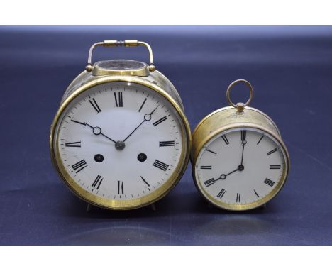 An unusual brass drum carriage clock, with 5in enamel dial and bell striking movement, height including handle 17cm; together