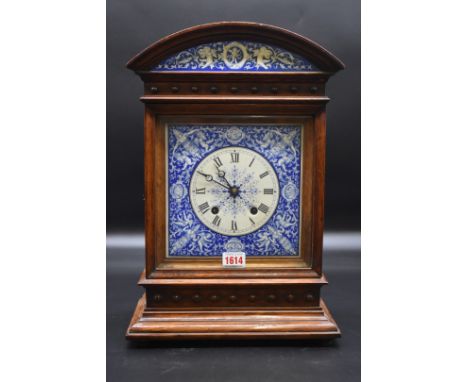 A late 19th century oak mantel clock,&nbsp;with 7 1/2in blue and white enamel dial, 43.5cm high, with pendulum.&nbsp; 