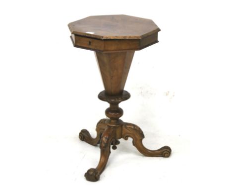 A Victorian burr walnut trumpet sewing table. The hinged octagonal top with a bevelled edge, opening to reveal textile lined 