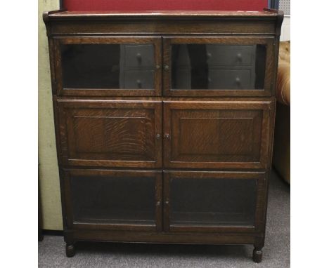 A vintage oak bookcase. With fitted glazed and blind panel doors. L89cm x D23cm x H111cm