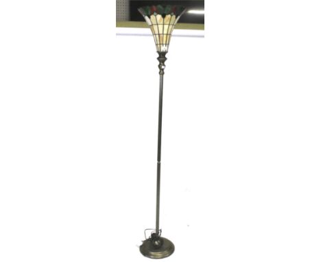 A Tiffany style standard lamp. The leaded glass shade of tapering form, mounted on a fluted metal column and circular base, H