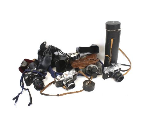 A collection of assorted vintage film cameras and lenses. Including Minolta 7000, Yashica 8-EIII cine camera, etc. 