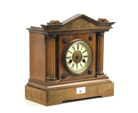 A German 14 day striking mantle clock. The cream and gilt dial with Roman numerals, within a mahogany case featuring fluted c