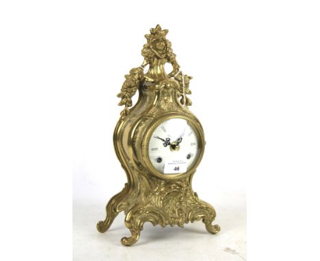 An Imperial contemporary rococo style Italian made brass mantel clock. With a German 2 jewel striking movement, the white ena