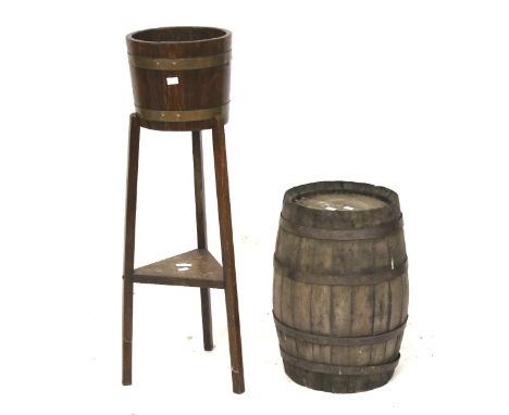 A vintage barrel and a raised plant stand modelled from a barrel. The wooden barrel with metal banding, H49cm, the plant stan