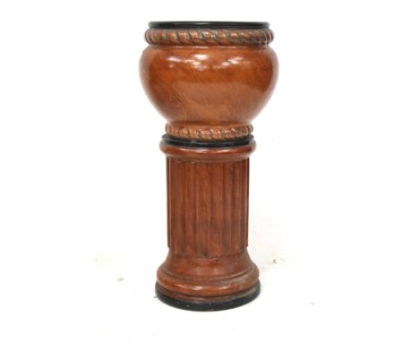 A 20th century ceramic jardiniere on stand. Glazed in light brown with a dark brown interior, on a circular base, H66cm