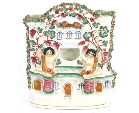 A 19th century Staffordshire ceramic watch stand. In the form of a castle with two cherubs. H25cm