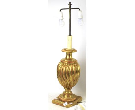 A contemporary gilt plaster table lamp. Of fluted baluster form on a square plinth. H80cm