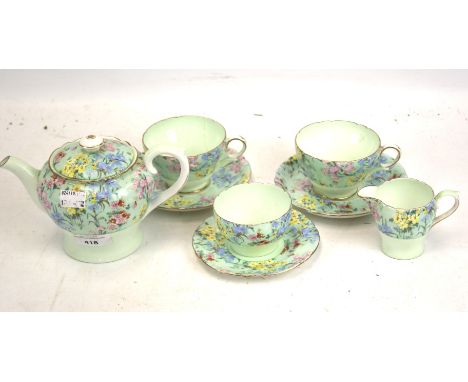 A vintage Shelley two piece tea service. In the 'Melody' pattern, comprising a teapot, two cups and saucers, a sugar bowl, pl