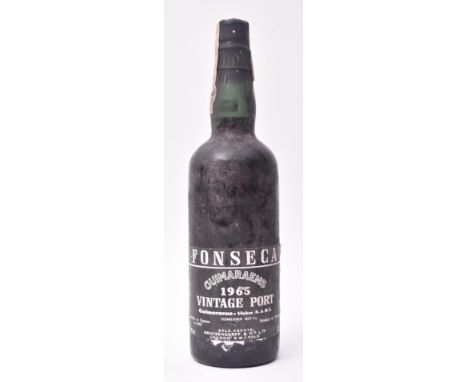 A vintage 1965 Fonseca Guimaraens Vintage Port bottle. Bottled in Oporto in 1968. Product of Portugal. 75cl. 21% vol. Seal in