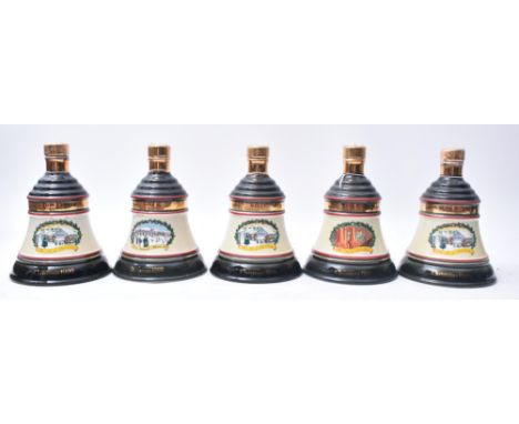 An assortment of vintage 20th century Bell's Old Scotch Whisky Wade porcelain Christmas bell decanters. The lot comprising a 