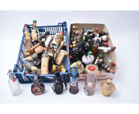 A collection of vintage 20th century miniature souvenir alcohol shaped decorated bottles. The lot comprising various Rynbende