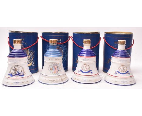 Four Bell's Old Scotch Whisky Wade porcelain Royal Family Commemorative decanters in cylindrical drums. The lot comprising tw