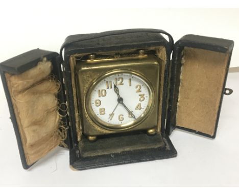 A Vintage traveling clockwork alarm clock in a fitted case. NO RESERVE