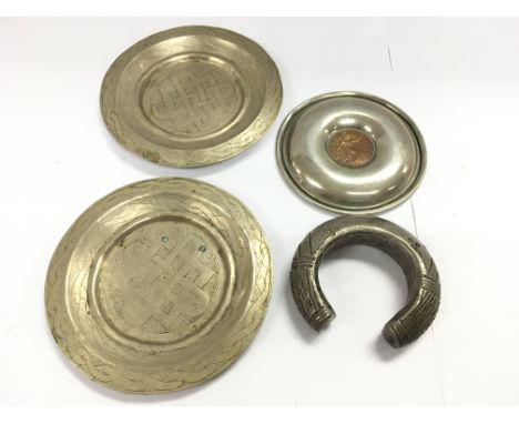 A Nigerian slave bangle and three silver plated dishes. Postage B