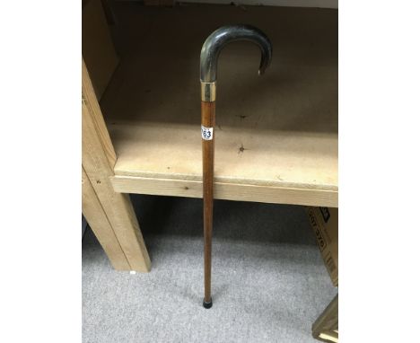 A walking stick with an 18ct gold cuff below the handle. Approx length 85cm.