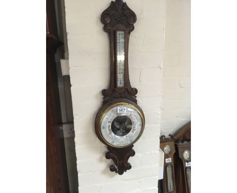 A Victorian carved oak Aneroid barometer with visible mechanism. Sold without reserve.