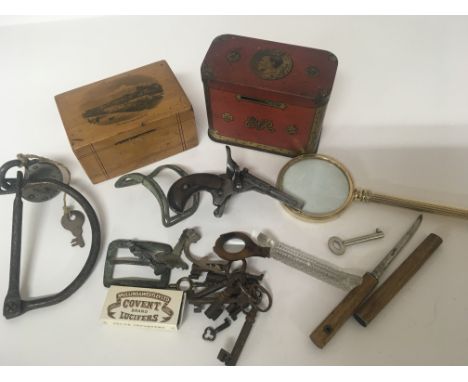 A collection of oddments vintage money boxes antique buckles keys and an Antique Belgium rim fire pocket pistol and other odd