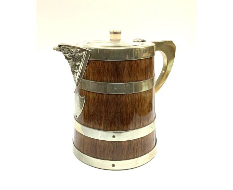 A Mappin and Webb antique oak and silvered brass water pitcher. 24cm.