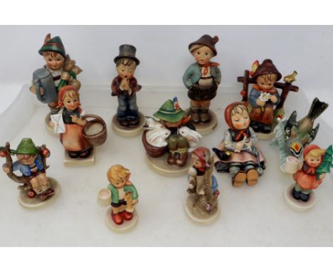 Eleven Goebel figures and a Goebel bird, largest H: 15 cm, small chip to hat on one figure. P&amp;P Group 3 (£25+VAT for the 