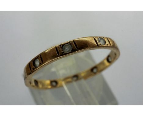 9ct gold stone set eternity ring, two stones missing, size Q/R, 1.2g. P&amp;P Group 1 (£14+VAT for the first lot and £1+VAT f