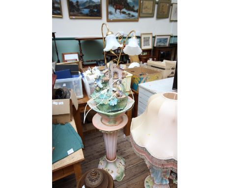 Large ornate light fitting of pottery and metal design on large base of similar design which includes a water feature 