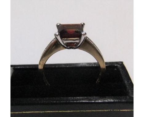 9ct gold ring with a princess cut garnet and with diamonds on each shoulderApprox 3.6 grams gross,            size P 