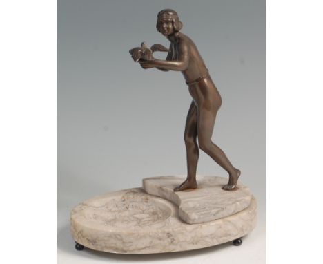 An Art Deco spelter model of a female standing nude, with a bird of prey perched in her left hand and holding a bowl in her r