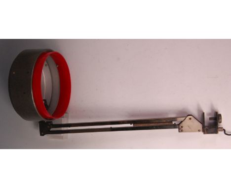 A 1970s Italian lacquered metal clamp light, having revolving action, circular shade with red plastic trim, h.65cm Condition 