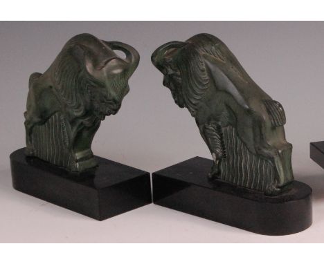In the manner of Max Le Verrier  (1891-1973) - A pair of Art Deco art metal bison book-ends, each in stylised rutting pose, w