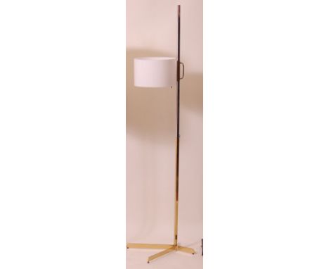 A 1970s chrome and gilt brass standard lamp, having adjustable rise-and-fall action, with white plastic integral shade, h.171