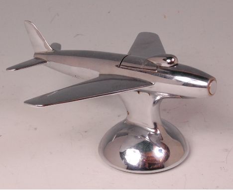 An Art Deco chrome refillable table lighter by Dunhill, in the form of a Sabre F-38 fighter jet, having hinged pop-up button 