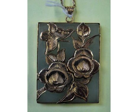 A Chinese jade Pendant of rectangular form in a 10K mount featuring butterfly and flowering foliage with a gilt metal neck ch