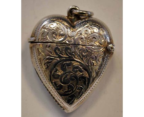 An Edwardian silver Vesta Case, heart shape with suspension ring, chased scrolling foliate surfaces, reserved with blank cart