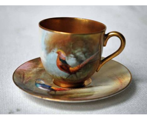 A small Royal Worcester hand painted Cabinet Cup and Saucer, decorated with Amherst Pheasant against a naturalistic backgroun