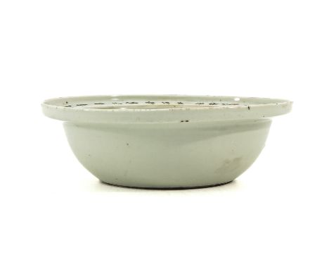 Depicting flowers and bird in center of basin with calligraphy on rim, 26 cm. in diameter, fritting.