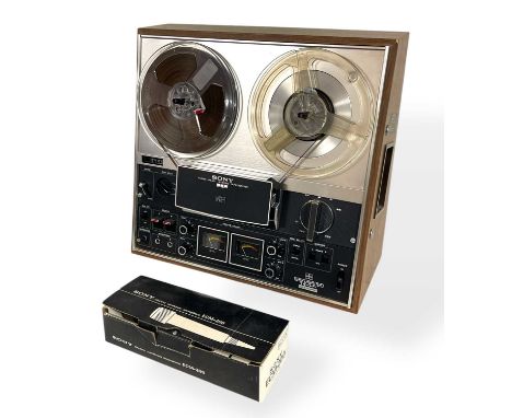 A Sony TC-377 reel-to-reel tape recorder. Powers on and appears to work fine. Microphone included.