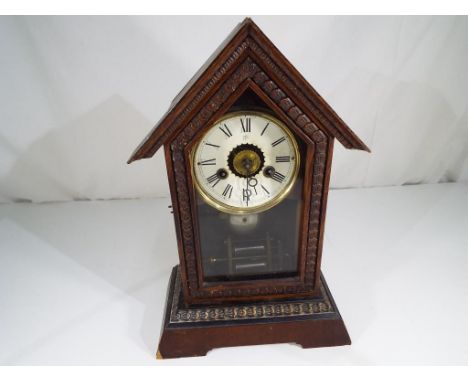A bracket clock Roman numerals on a white dial with pendulum and key, 35 cm (h)