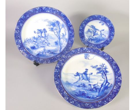 PAIR OF ROYAL DOULTON BLUE AND WHITE HUNTING SERIES WARE POTTERY LARGE PLATES, printed and washed with horses and hounds, wit