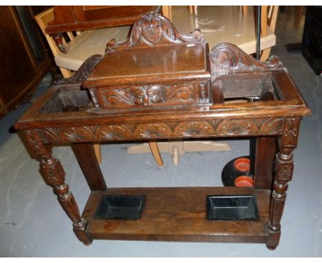 A VICTORIAN OAK GREEN MAN STYLE STICK/HALL STAND, SHAPED RAISED BACK OVER CENTRAL DRAWER WITH FOLIATE AND CAT CARVED CUP HAND